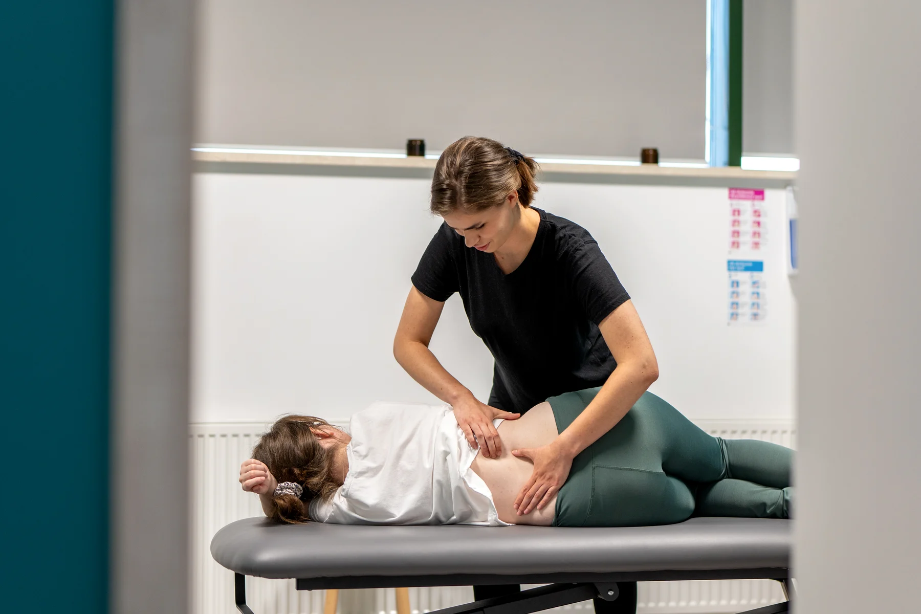 Terapia indywidualna w M&M Zdrowy Masaż — fizjoterapeutka Kasia pracuje z pacjentką leżącą na kozetce
